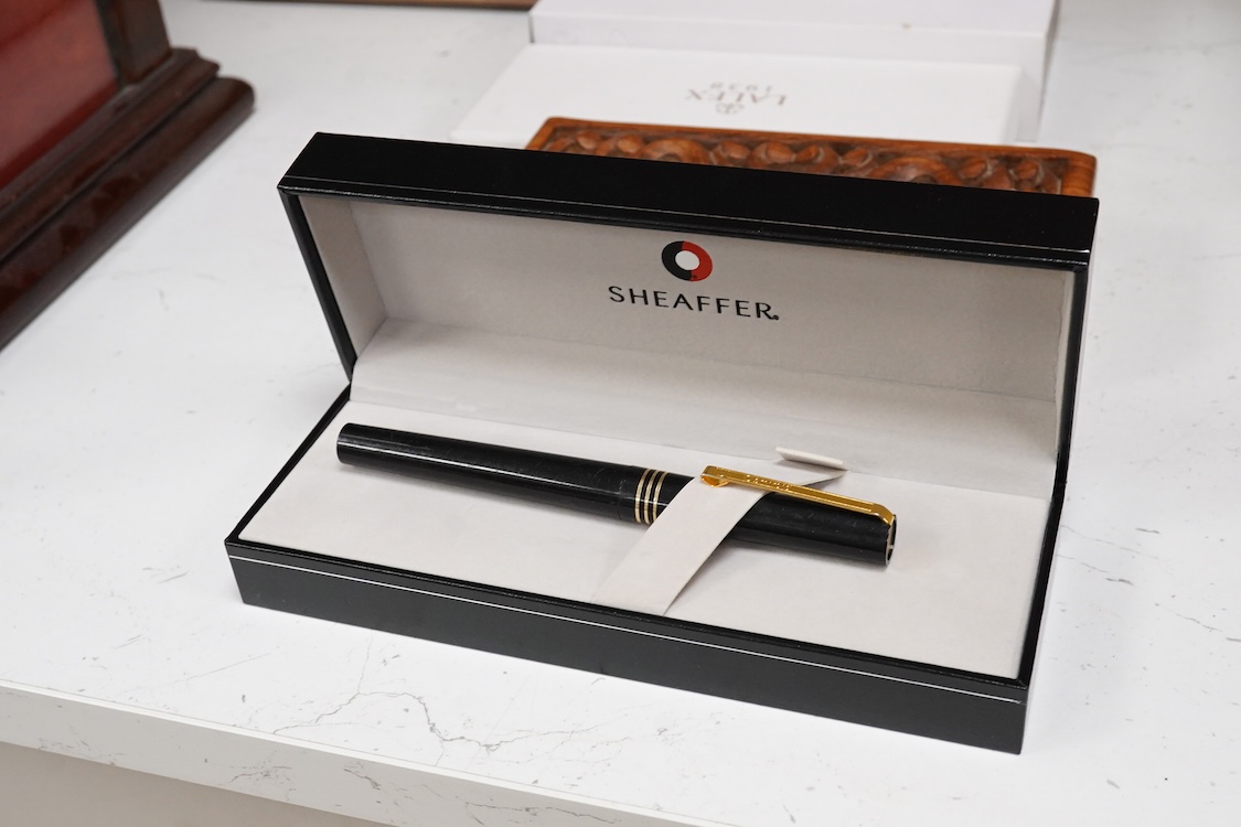 A group of five fountain pens and ballpoint pens